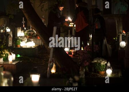 People light a candle at Rakowicki cemetery in Krakow, Poland 2019. Stock Photo