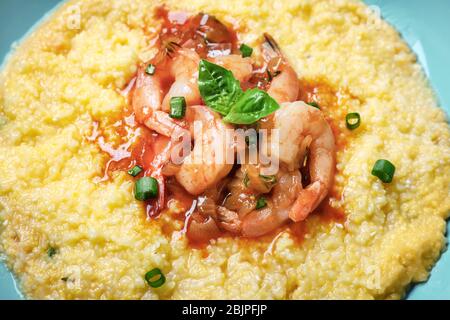 Shrimp & grits side dish appetizer in fancy martini cocktail glasses -  steaming hot southern comfort Stock Photo by wirestock