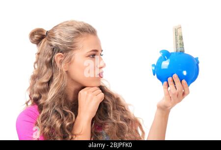 Young woman holding piggy bank on white background Stock Photo