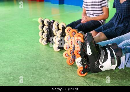 Group of teenagers wearing roller skates indoors, closeup Stock Photo
