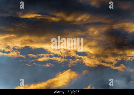 Beautiful view natural meteorology abstract background.Fluffy clouds illuminated by disappearing rays at sunset and dark thunderclouds in sky Stock Photo