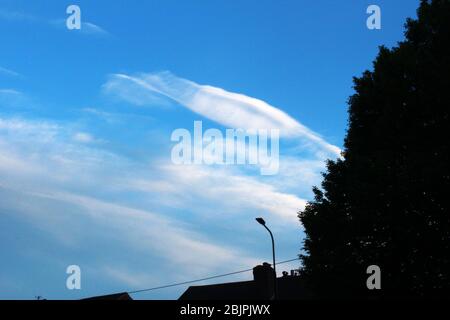 Pretty white clouds in a clear, blue sky in Manchester, England Stock Photo