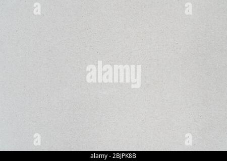Gray color background from sheet of recycled cardboard. Close-up detail view of abstract texture recycled carton material pattern background Stock Photo