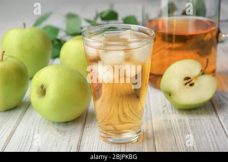 Glass with fresh apple juice on wooden table Stock Photo