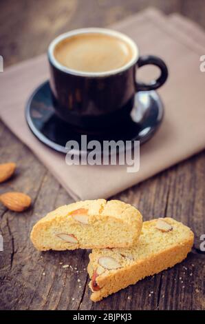 Good morning concept - breakfast frothy espresso coffee accompanied by delicious Italian almond cantuccini biscuits. Traditional italian biscotti cant Stock Photo
