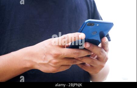Young Indian man using smartphone Stock Photo
