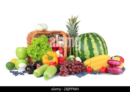 Wicker basket with different fruits and vegetables on white background ...
