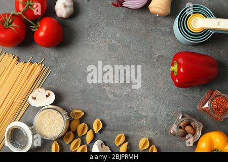 Kitchen utensils and food ingredients on grey background Stock Photo
