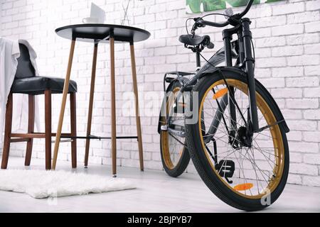 Modern room interior with small table and bicycle Stock Photo