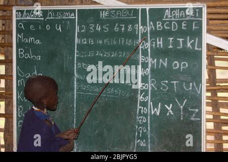 Young Maasai children learning arithmetic and reading in a school room Photographed at Lake Eyasi, Tanzania Stock Photo