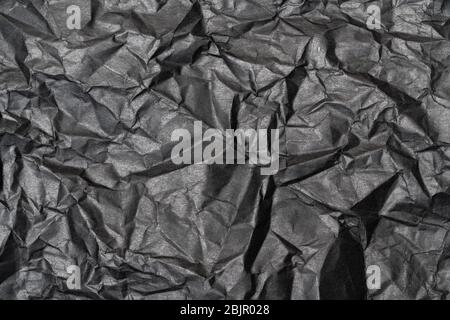 Close-up detail black color background from sheet of crumpled carton, detail macro view of abstract texture cardboard material pattern background Stock Photo