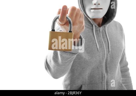 Hacker in mask holding lock on white background Stock Photo