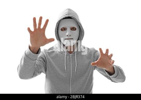Hacker in mask working with virtual screen on white background Stock Photo