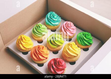 Tasty colorful cupcakes in cardboard box Stock Photo