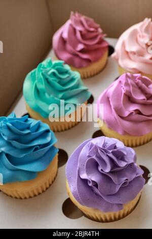 Tasty colorful cupcakes in cardboard box Stock Photo