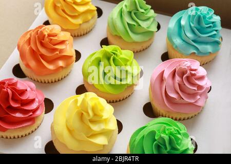 Tasty colorful cupcakes in cardboard box Stock Photo