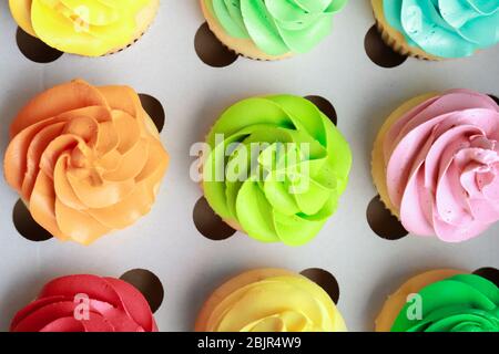Tasty colorful cupcakes in cardboard box Stock Photo