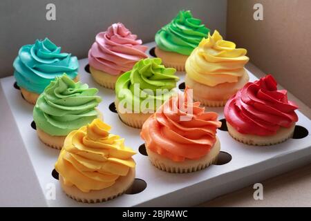 Tasty colorful cupcakes in cardboard box Stock Photo