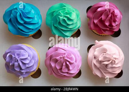 Tasty colorful cupcakes in cardboard box Stock Photo