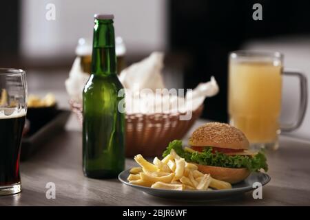 Beer and hamburger on table in sport bar Stock Photo