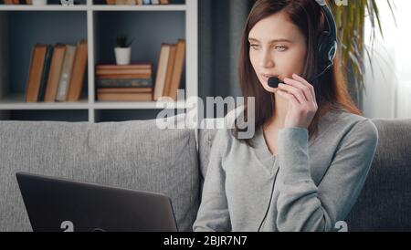 Female using laptop and headset Stock Photo