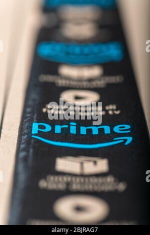 Paris, France - February, 20, 2020  : Amazon Prime logotype printed on cardboard box security scotch tape. Amazon Prime is a service from Amazon which Stock Photo