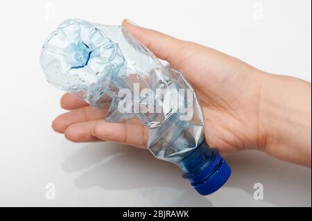 Plastic bottle in hand isolated on white studio background Stock Photo