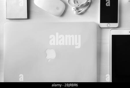 KYIV, UKRAINE - OCTOBER 23, 2017: Flat lay composition with Apple MacBook Air Silver, iPad mini 4 and iPhone 6s on wooden background Stock Photo