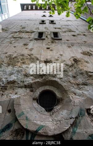 Bullet holes and shell holes on the facade of the Reichsbahnbunker air raid shelter in central Berlin Stock Photo