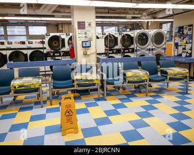 Benches in the laundry room of an apartment building in New York are alternately taped over to prevent sitting to facilitate compliance with social distancing, seen on Thursday, April 23, 2020. (© Richard B. Levine) Stock Photo