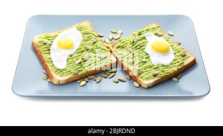 Plate with toasts, avocado paste and fried eggs, isolated on white Stock Photo