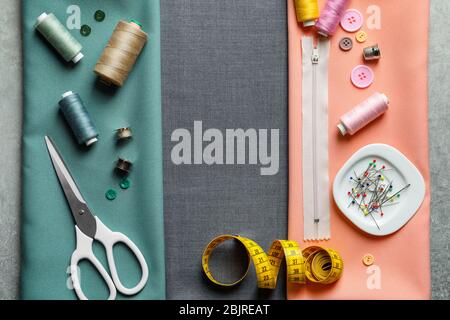 Set of tailoring tools and accessories on fabric, top view Stock Photo