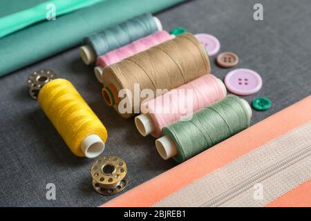 Set of tailoring tools and accessories on fabric, closeup Stock Photo