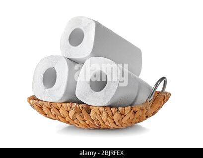 Wicker basket with rolls of paper towels on white background Stock Photo