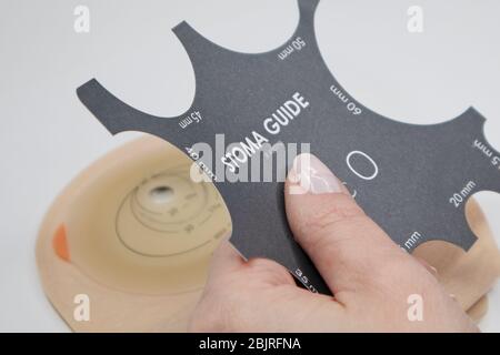 Top view on colostomy bag, supplies needed after colostomy surgery - colon cancer treatment. Ostomy bag with filter in skin color. Medical theme. Stom Stock Photo