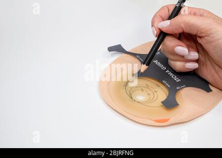 Top view on colostomy bag, supplies needed after colostomy surgery - colon cancer treatment. Ostomy bag with filter in skin color. Medical theme. Stom Stock Photo