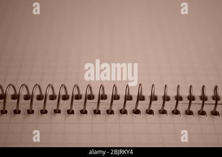 open notebook on a spiral closeup, paper in cage. Stock Photo