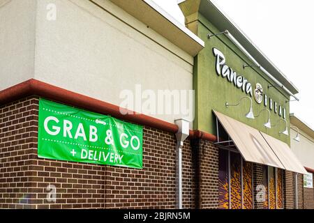 Herndon, USA - April 27, 2020: Virginia Fairfax County building exterior sign for grab and go Panera restaurant for take-out curbside during coronavir Stock Photo