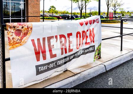 Herndon, USA - April 27, 2020: Virginia Fairfax County street with sign for open pizza restaurant for take-out curbside and delivery during coronaviru Stock Photo