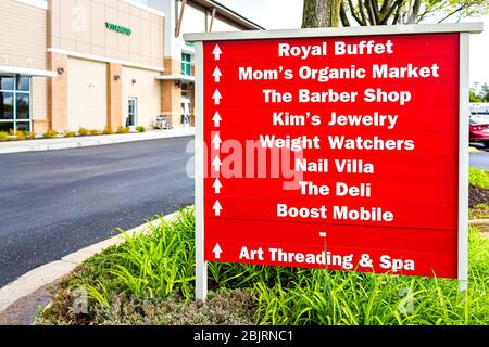 Herndon, USA - April 27, 2020: Virginia Fairfax County building exterior sign in strip mall for Mom's Organic Market store shop, buffet restaurant, ba Stock Photo