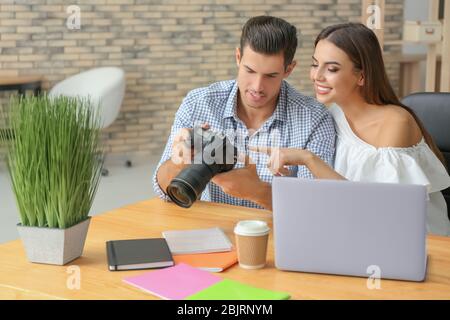 Two young photographers working in office Stock Photo