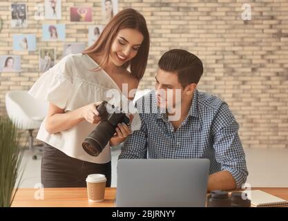 Two young photographers working in office Stock Photo