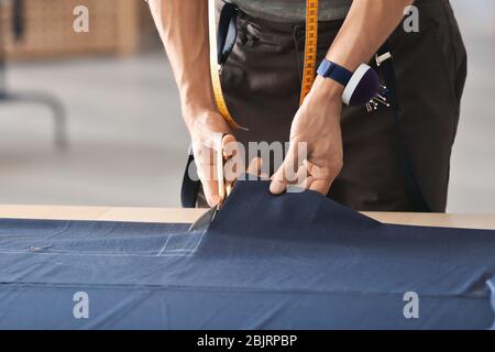 Young tailor working with textile in atelier Stock Photo