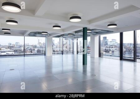 Looking out of the upper floor windows  towards the city. 75 Farringdon Road, London, United Kingdom. Architect: Buckley Grey Yoeman, 2019. Stock Photo