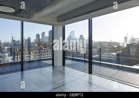 Looking out of the upper floor windows  towards the city. 75 Farringdon Road, London, United Kingdom. Architect: Buckley Grey Yoeman, 2019. Stock Photo