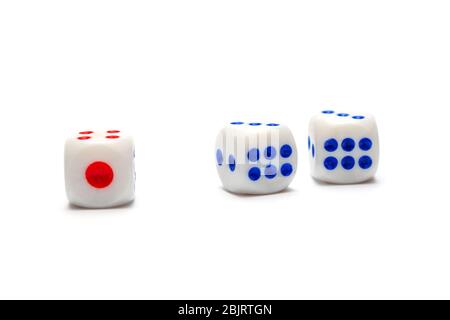Three dice, one red and two blue on a white background. isolate Stock Photo