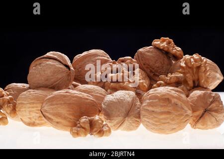 open and closed chestnuts with back light on black background. Stock Photo