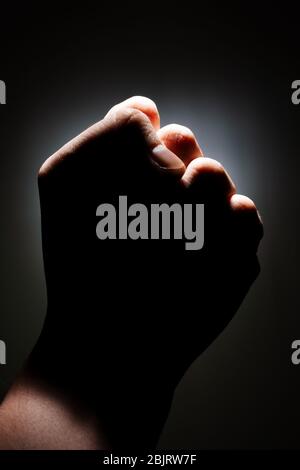 male fist  strength on a dark background isolate. copy space close up Stock Photo