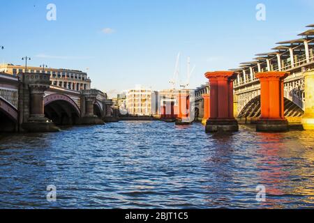 The Blackfriars Bridge, Blackfriars Railway Bridge and the supporting columns of the old Victorian era Railway bridge, in London, UK Stock Photo