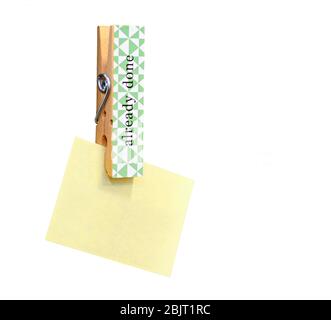 Yellow stick note paper pinned on wooden peg isolated on white background. Copy space for other notes on right side. Stock Photo
